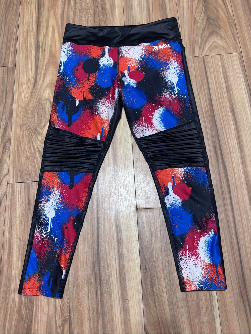 Zumba Must Move ankle leggings red & blue paint splatter w/ moto-style pleated